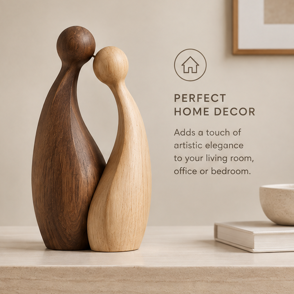 Light and dark wood couple sculpture on a console beside books and a decorative bowl