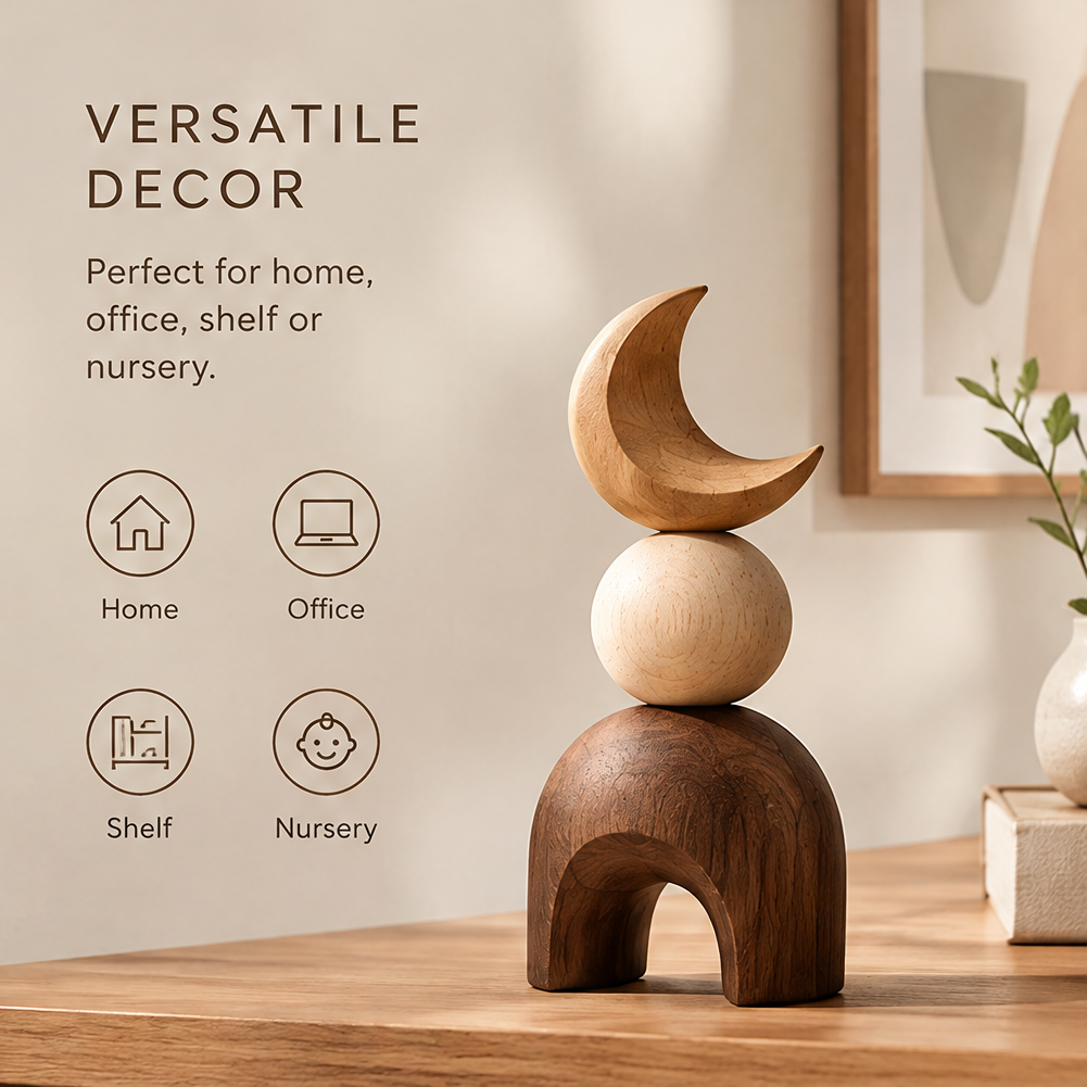 Stacked crescent moon wood sculpture styled on a console beside framed artwork and a vase