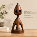 Front view of AVOLTT abstract solid wood figure with a teardrop head, two oval openings, and a circular base